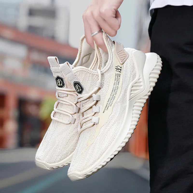 Men's white mesh sports shoes with rubber sole and round toe design on neutral background