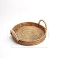 Handwoven rattan storage basket with wooden handle in three size options for home organisation