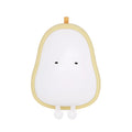 Yellow silicone pear-shaped rechargeable LED night light on a surface