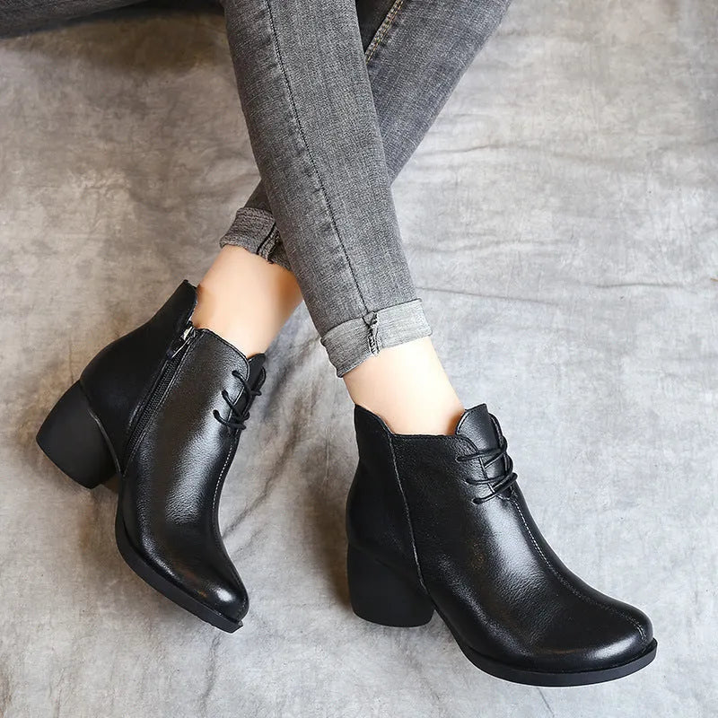 Women's brown leather Martin boots with 3-5cm thick heel and round toe on wooden floor