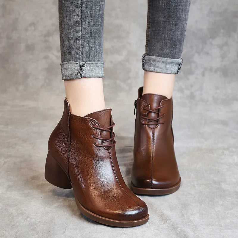 Women's brown leather Martin boots with 3-5cm thick heel and round toe on wooden floor