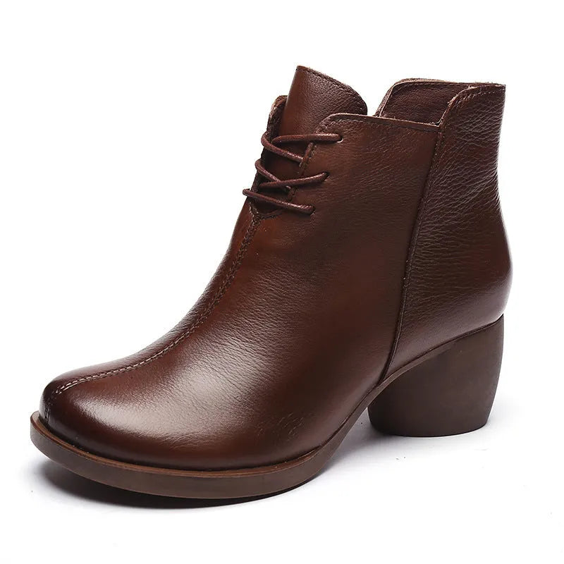 Women's brown leather Martin boots with 3-5cm thick heel and round toe on wooden floor