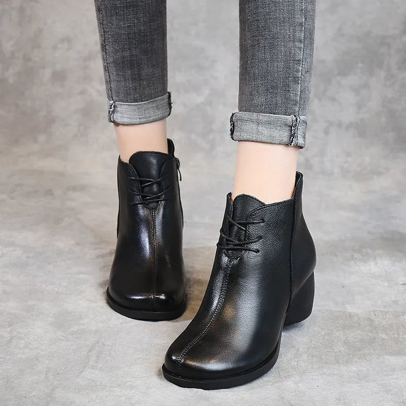 Women's brown leather Martin boots with 3-5cm thick heel and round toe on wooden floor