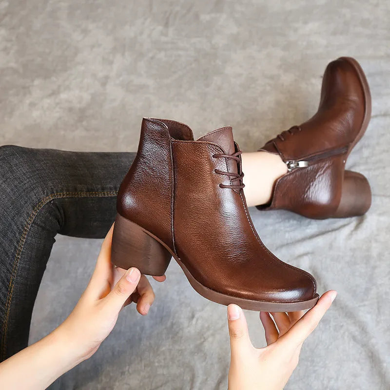 Women's brown leather Martin boots with 3-5cm thick heel and round toe on wooden floor