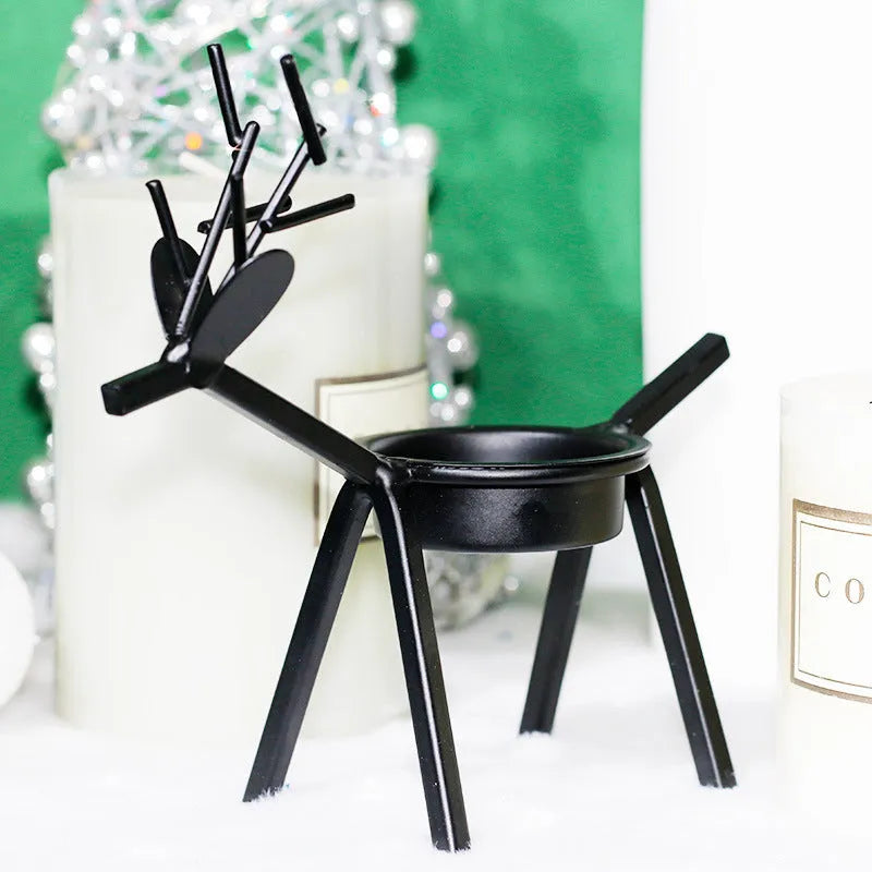 Black iron Christmas deer candlestick holder with Santa and snowman designs, 15cm height