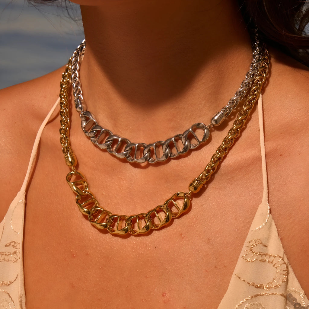 Stainless steel geometric necklace for women, shown in gold-plated and steel finish options.