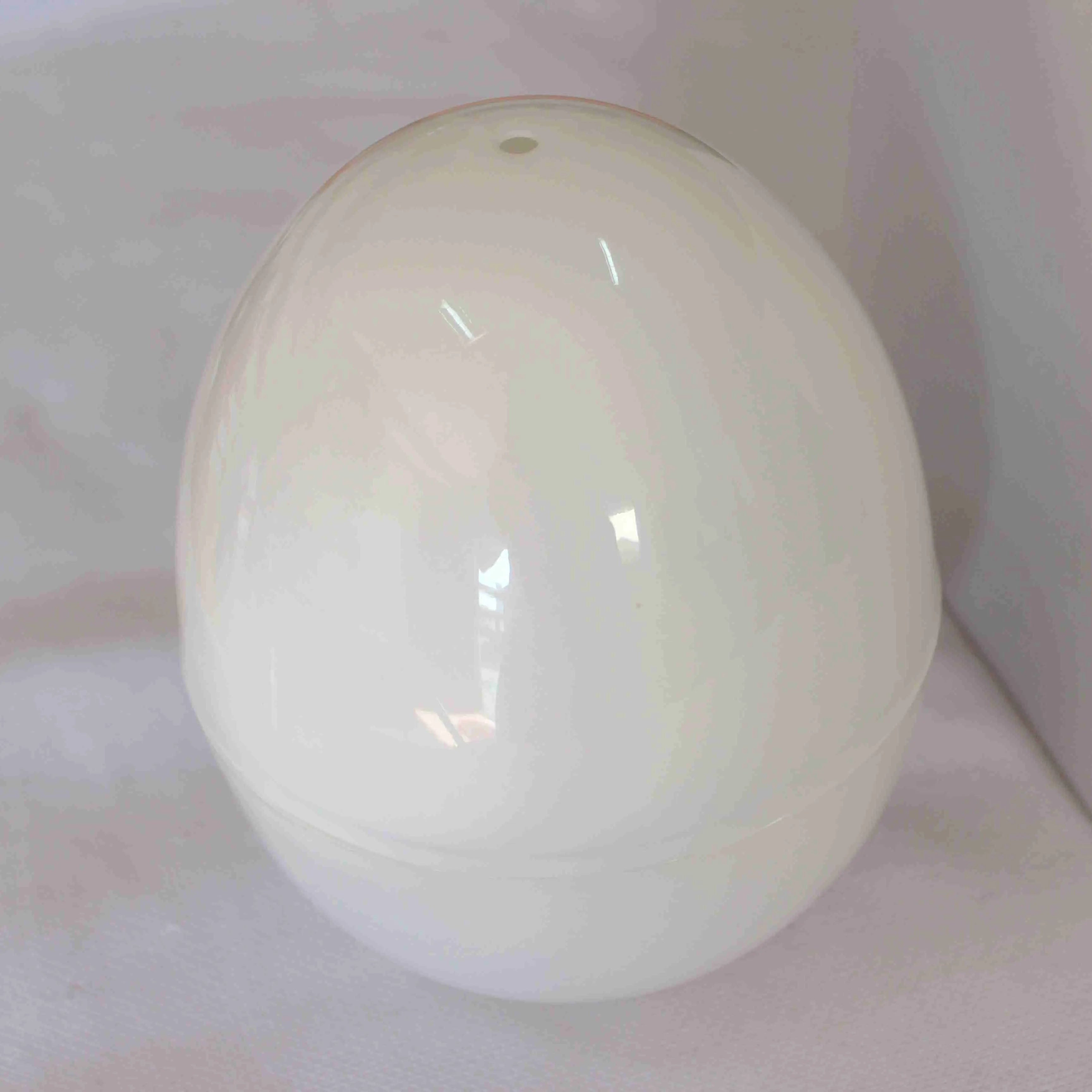 White microwave egg cooker steamer with capacity for four eggs, showing vent hole and knob.