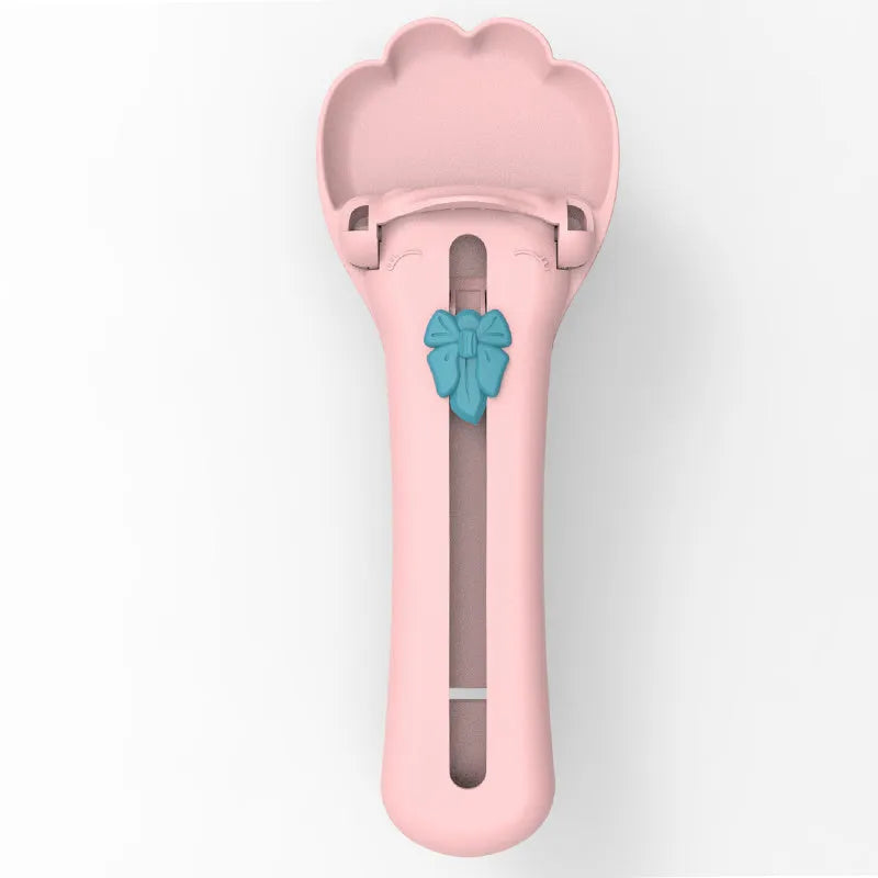 Green and pink pet feed spoon with extrusion design for dispensing cat treats and liquid food
