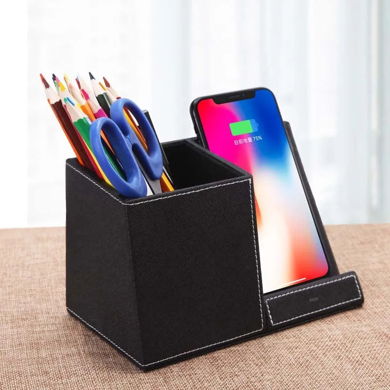 Black leather pen holder wireless charger on desk with phone charging and pens stored