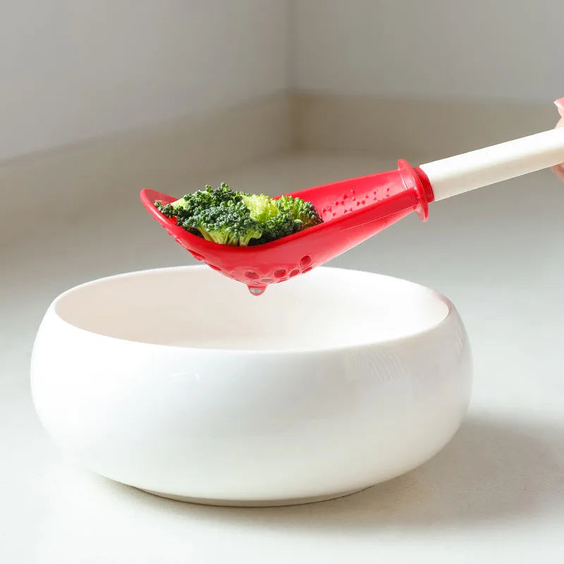 Red and black multifunctional slotted spoon with grinding serrations and half-enclosed head for kitchen use