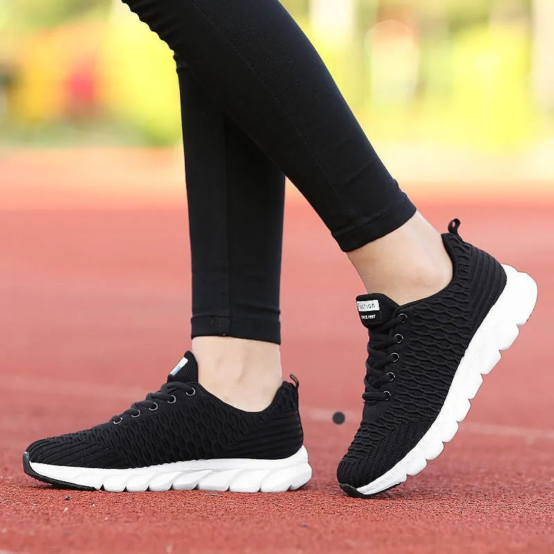 Women's running shoes with fly weaving upper in black, pink, or white, showing wear-resistant outsole