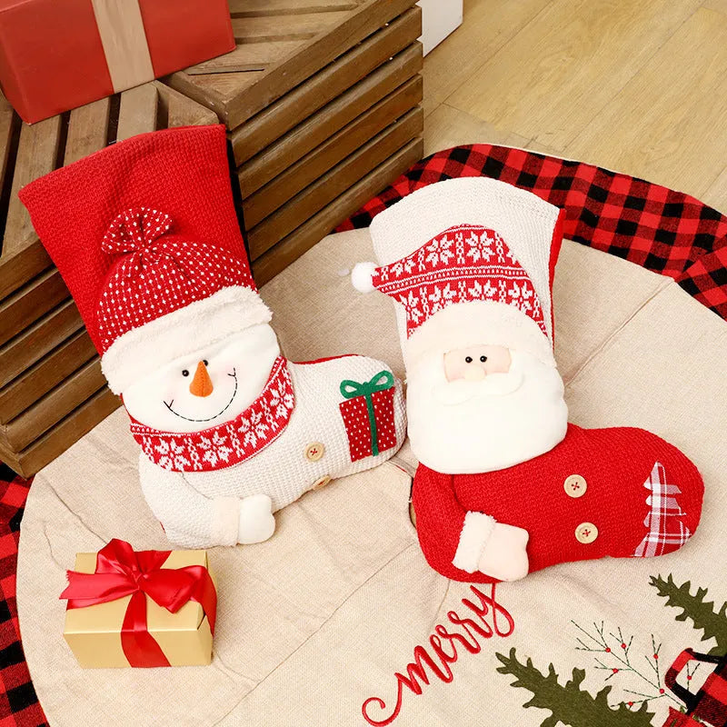 Large red white knitted Christmas stocking with Santa Claus design hanging above fireplace