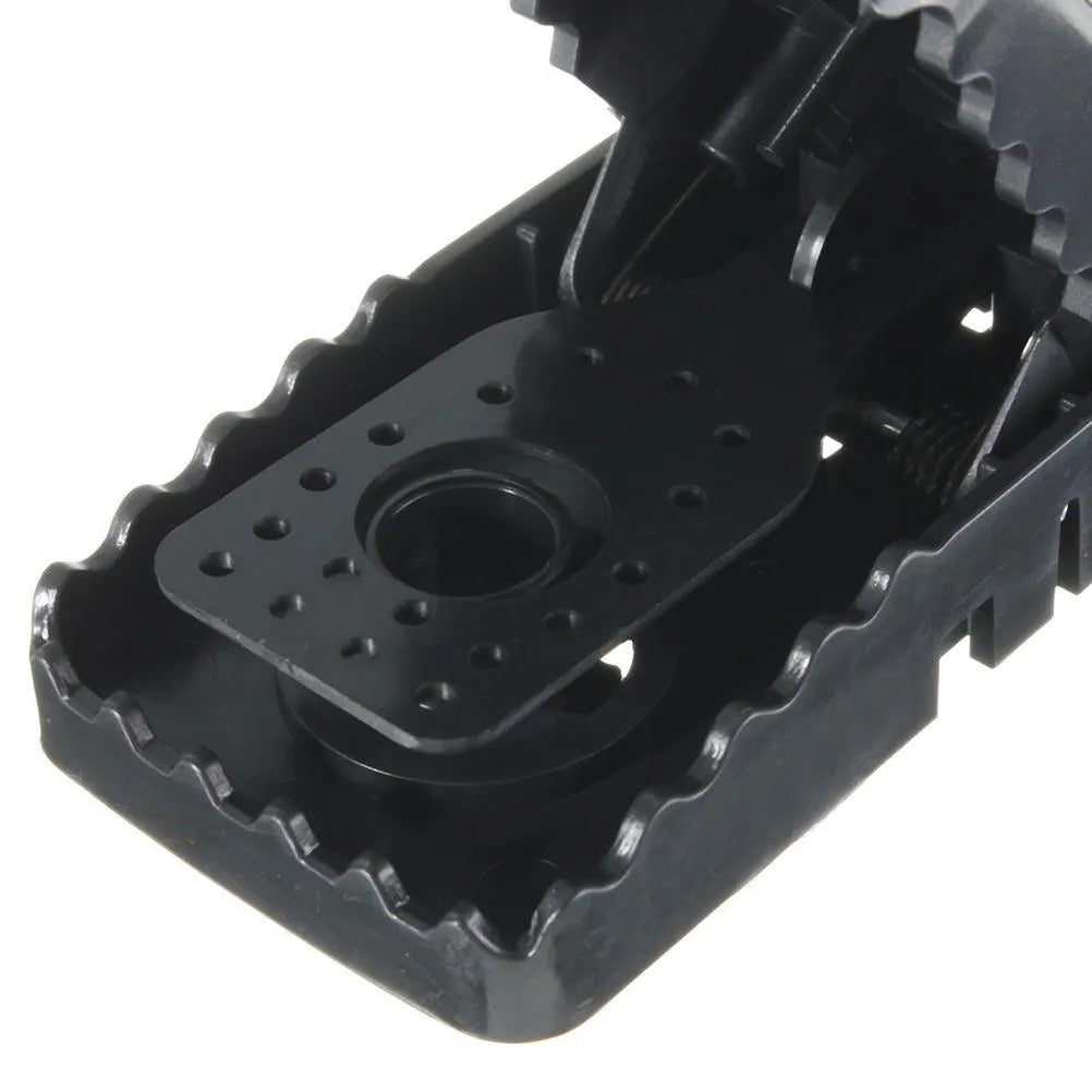 Six black plastic snap mousetraps showing smooth surface and compact size