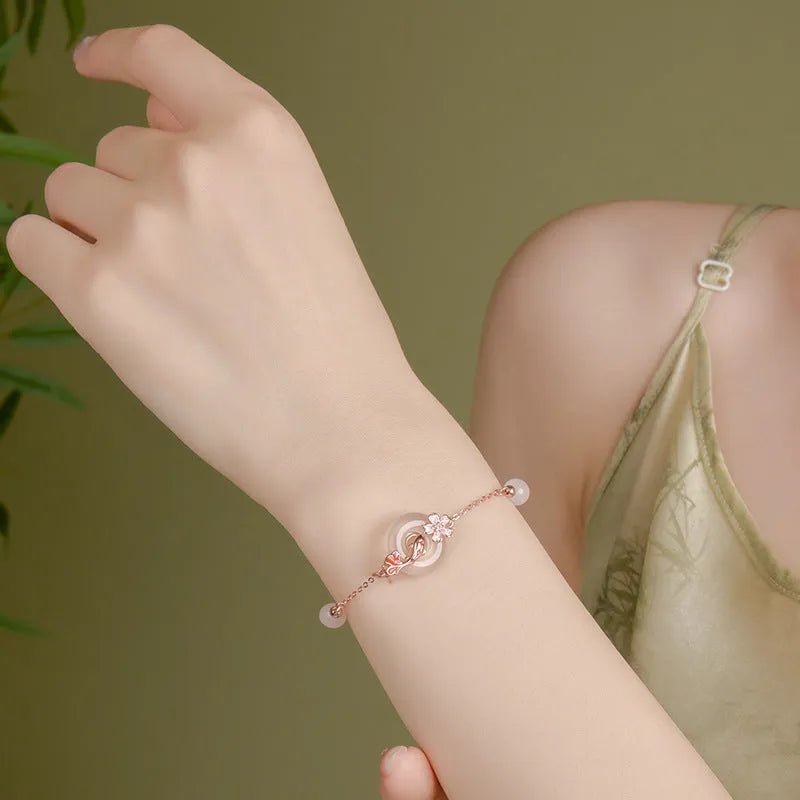 S925 sterling silver bracelet with white chalcedony crystal flower and engraved koi fish design.