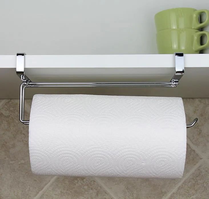 Silver stainless steel cabinet door back hanging paper towel rack on a kitchen cabinet.