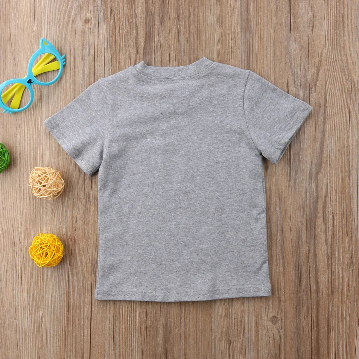 A grey printed cotton t-shirt for children showing a screen-printed graphic design on the front.