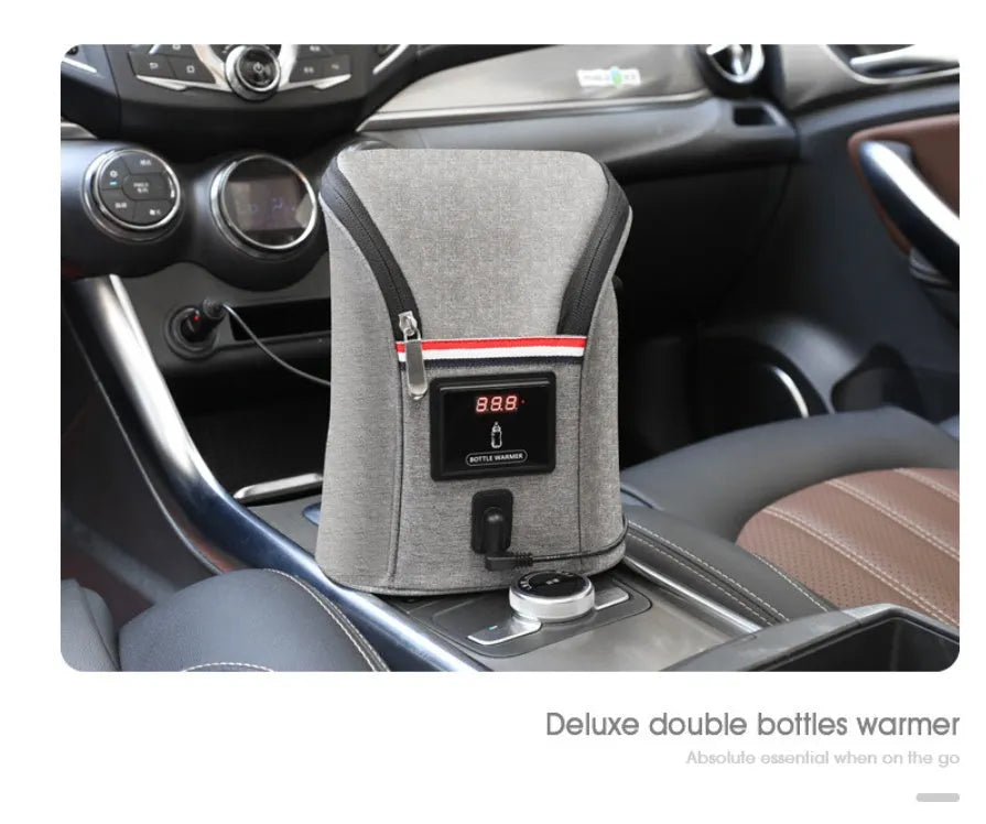 Grey portable baby bottle warmer with electronic display, car charger, and buckle for hanging on prams
