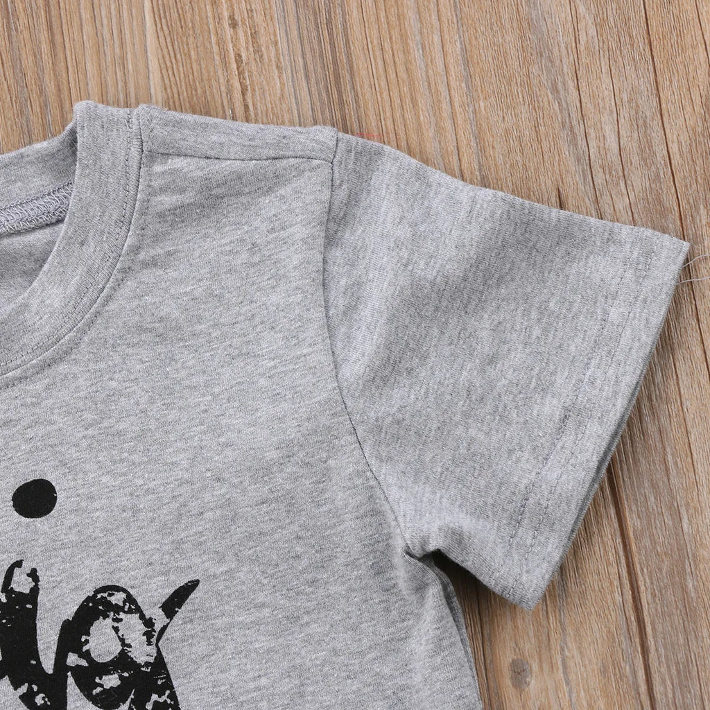 A grey printed cotton t-shirt for children showing a screen-printed graphic design on the front.