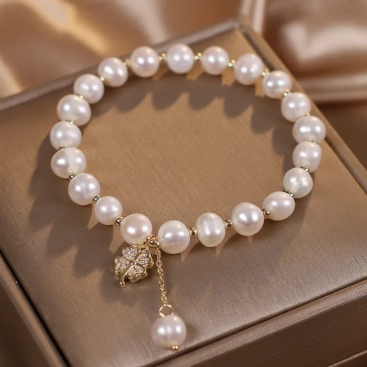 White freshwater pearl bracelet with four-leaf clover charm, alloy material, and sequin detail for women