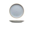A 10-inch diameter pure blue matte ceramic dinner plate with a subtle textured finish on a wooden table.