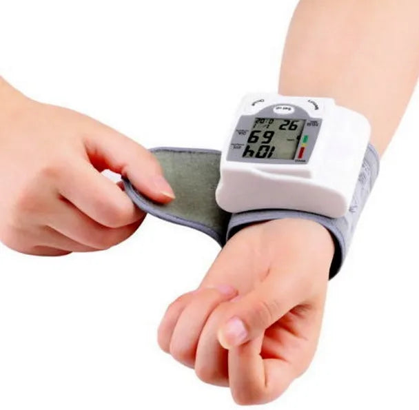 Grey portable wrist blood pressure monitor with digital display showing 70mm dimensions