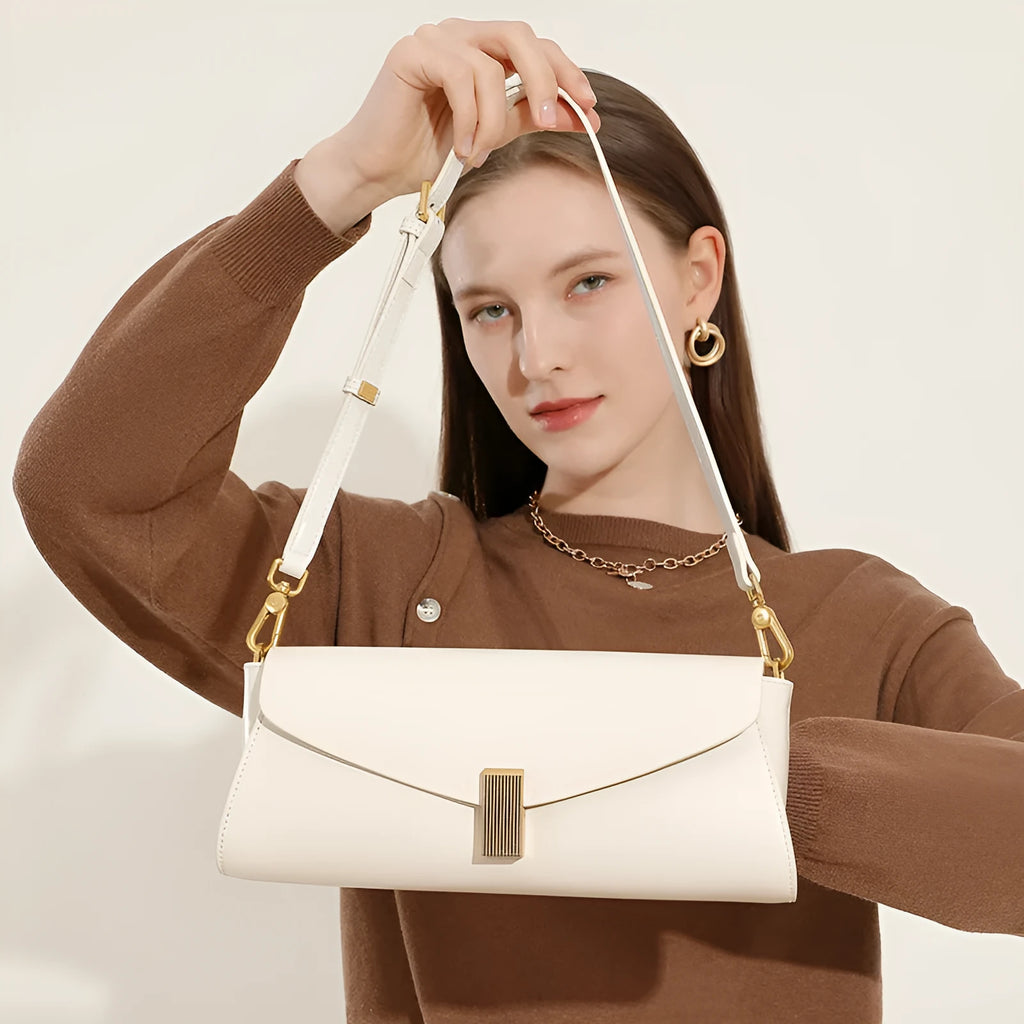 Milky white cowhide leather women's crossbody bag showing clamshell opening and pillow shape.