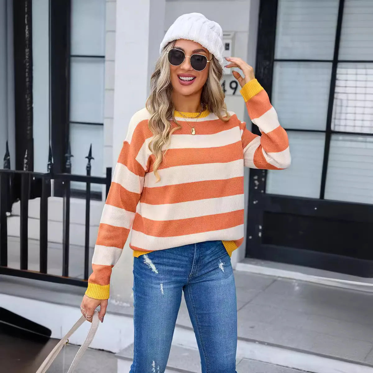 Women's loose-fit long sleeve acrylic sweater with round neck in striped or plaid pattern