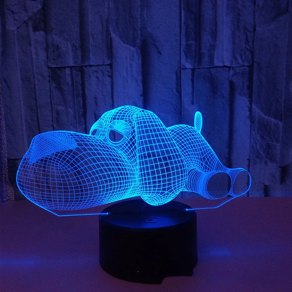 Doggo shaped 3D illusion desktop lamp glowing in multiple colours on a desk.