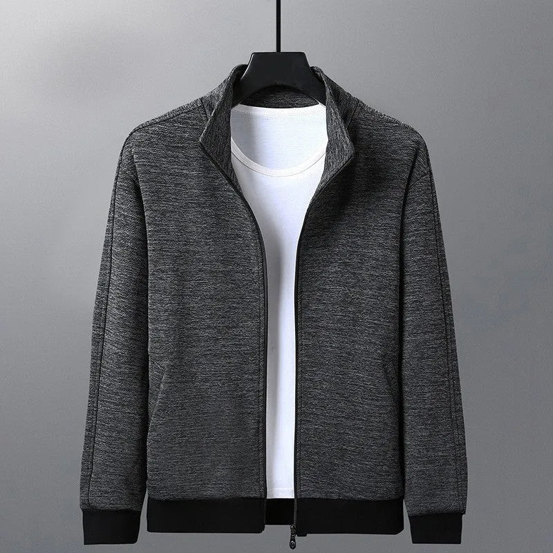 Men's black athletic jacket with stand-up collar and zip front, shown on a model.