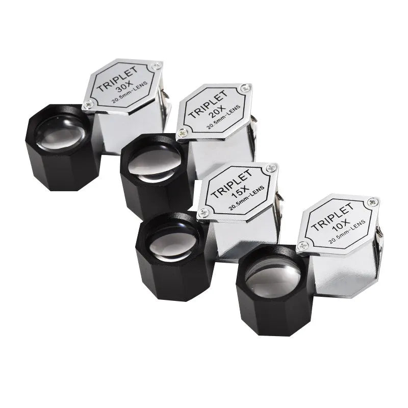 Handheld metal and optical glass magnifying loupe for jewellery and coin inspection.