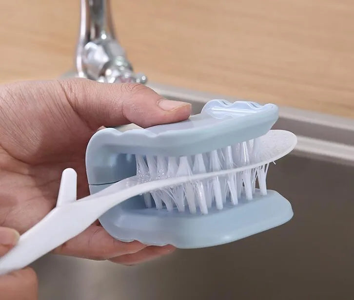 Blue U-shaped plastic brush for cleaning kitchen knives and cutlery on a kitchen counter.