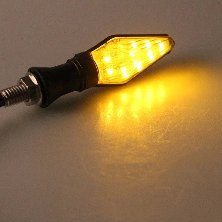 Motorcycle turn signal lights with plastic LED construction showing yellow and blue illumination