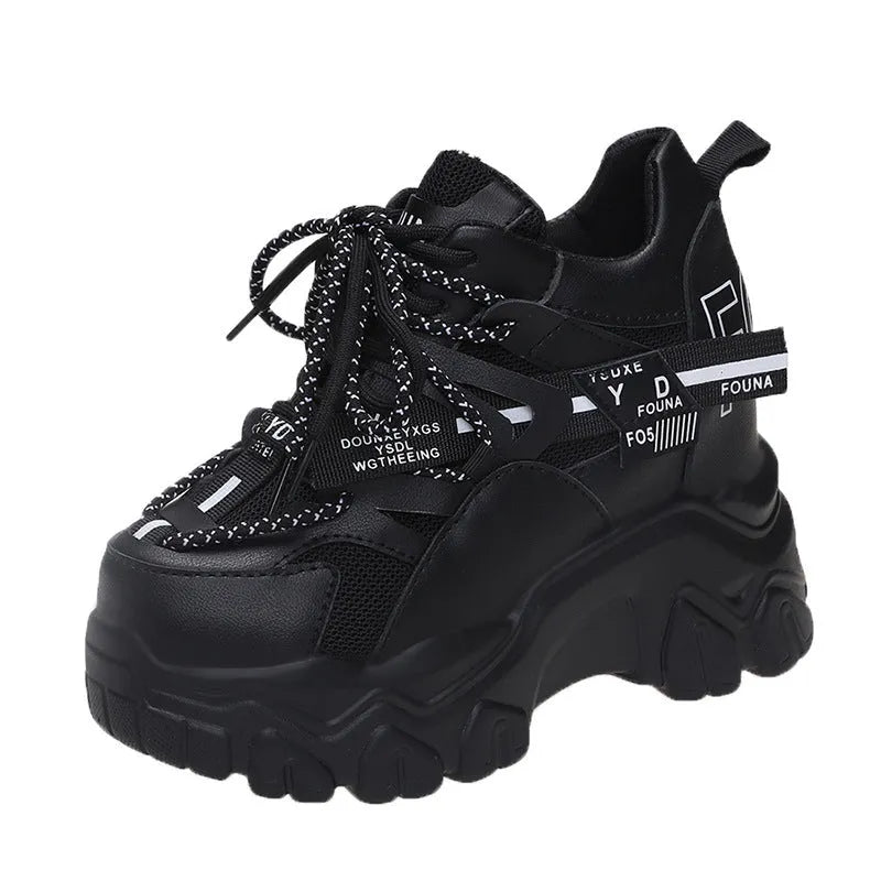 Women's white low-top platform sports shoes with cross strap and rubber sole on a light background