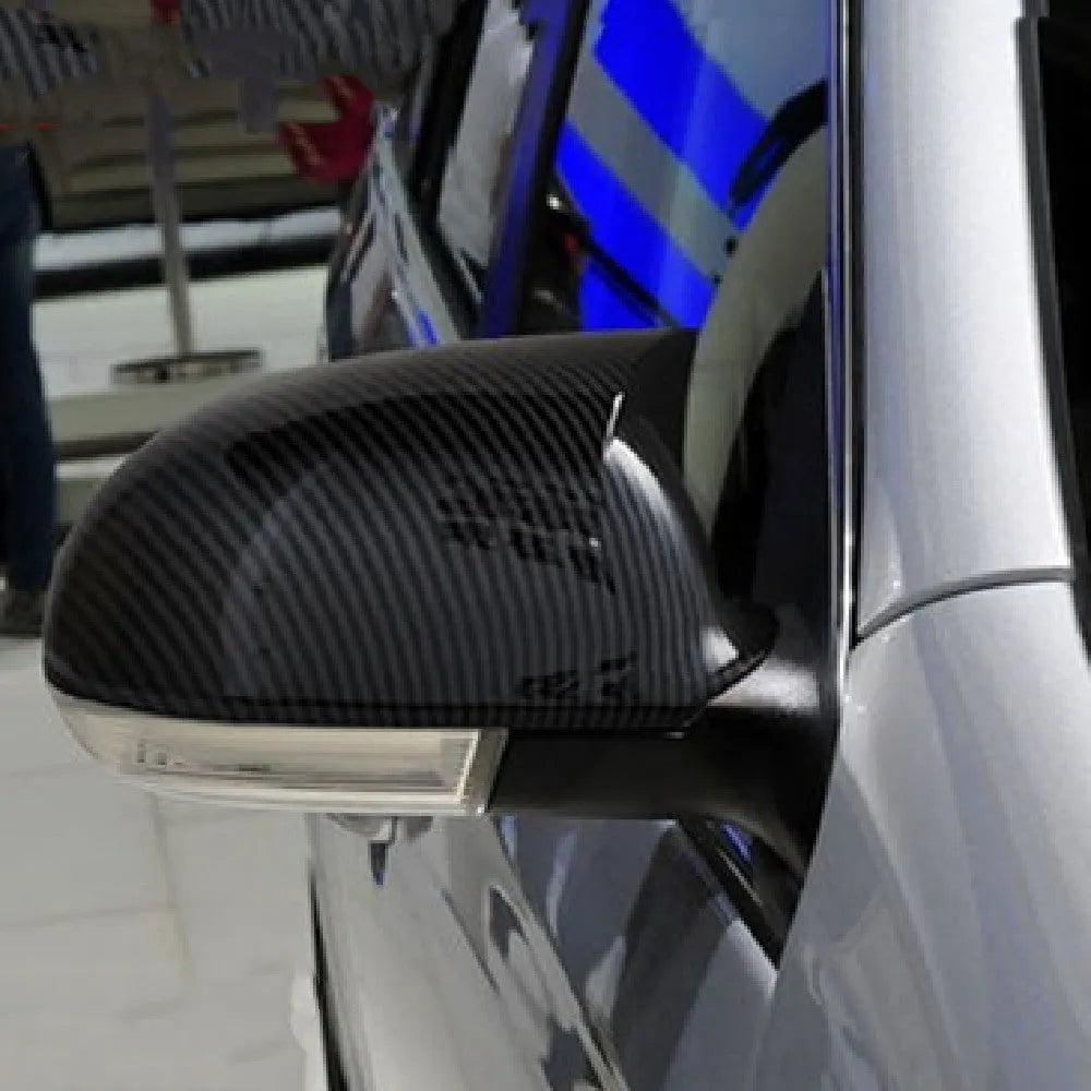 Bright black plastic mirror reflector shell pair for a Volkswagen Sagitar car.