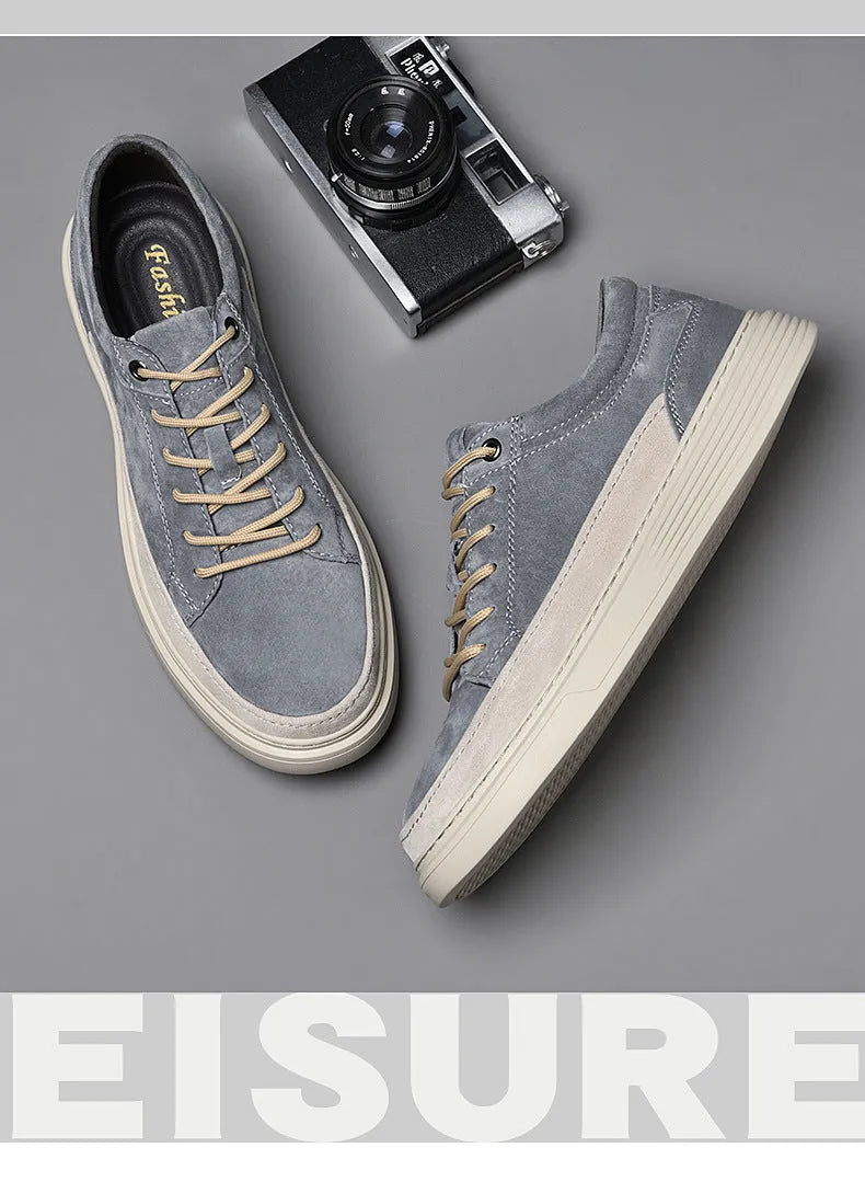 Men's grey casual skate shoes with pigskin upper and rubber sole showing lace-up front and round toe design