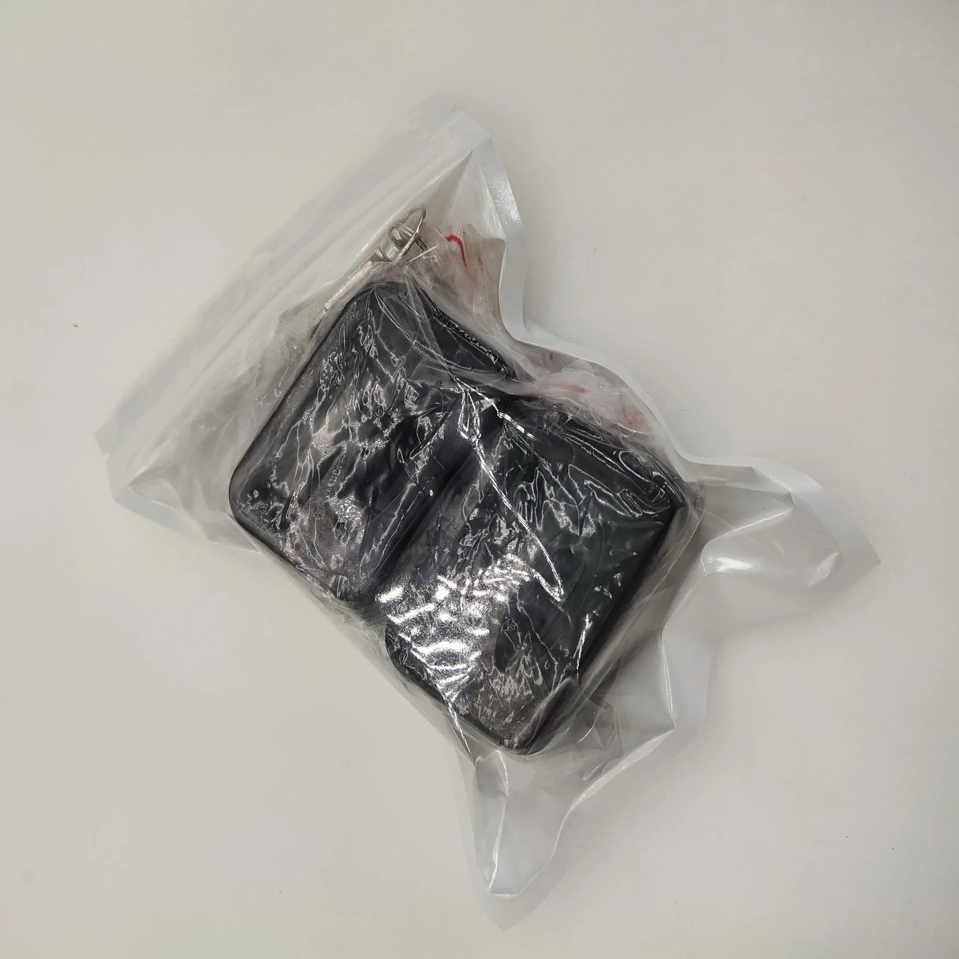 Seat belt buckle protective device in plastic ABS material shown in black and red colour options