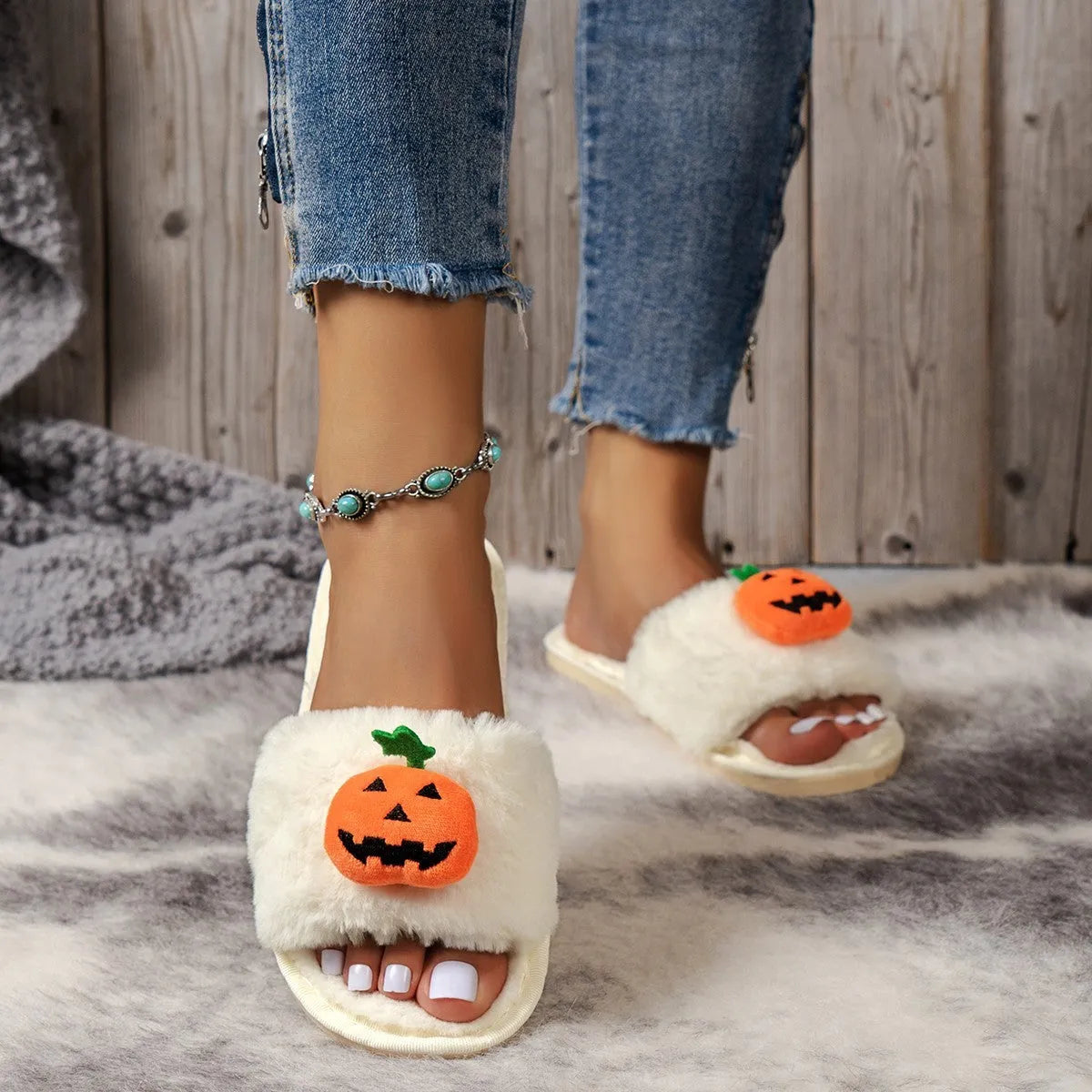 Halloween pumpkin plush slippers with open toe design showing synthetic fur uppers and PVC soles