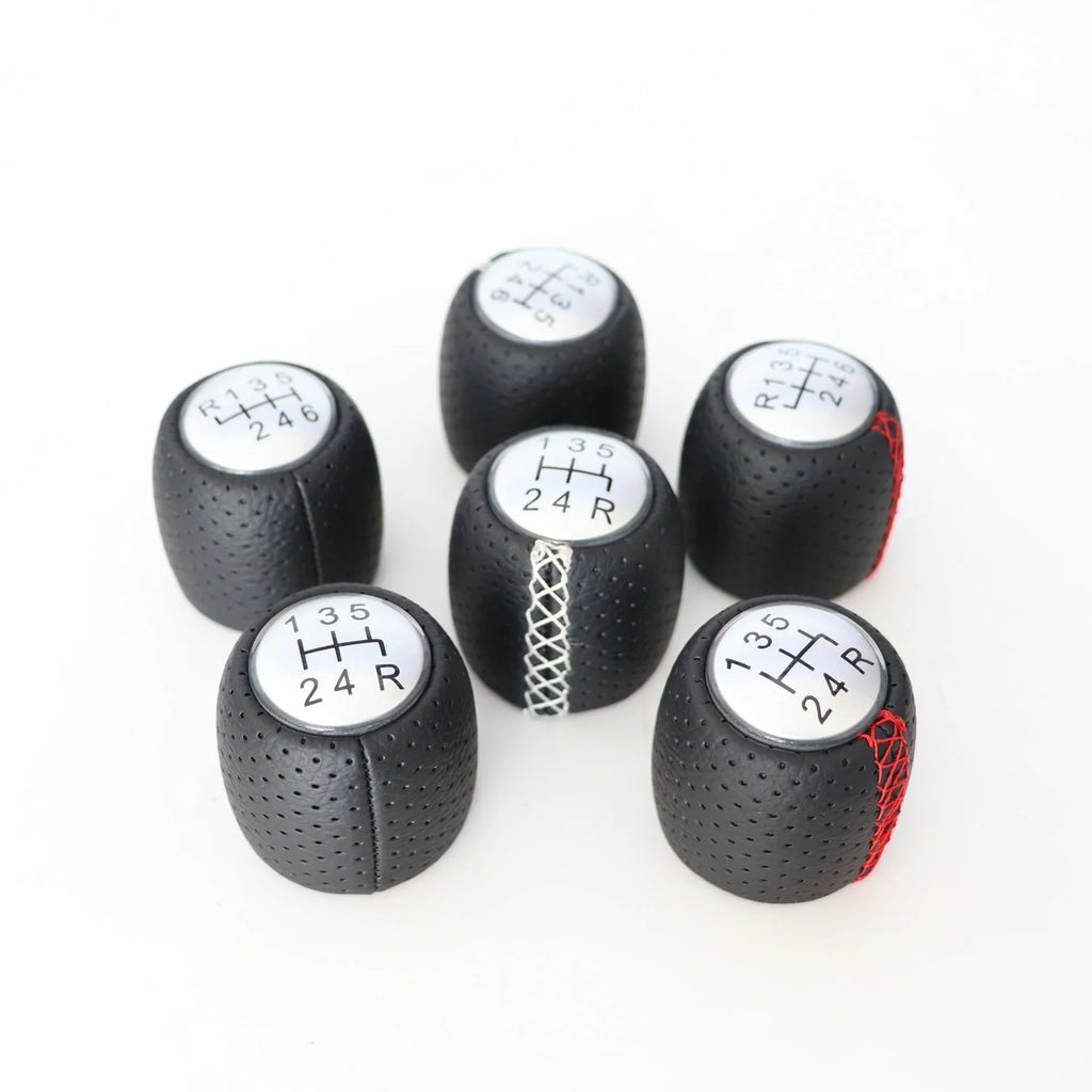 Sewn wrapped leather perforated handball gear for Alpha vehicles in matte and silver finishes