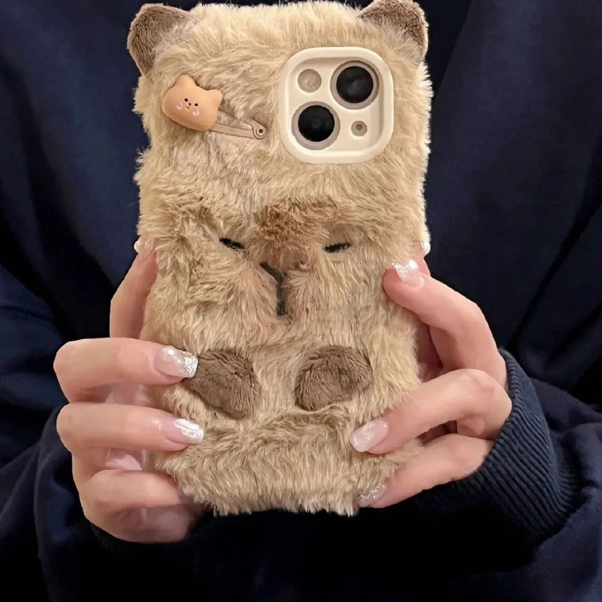 Brown flannel Capabala phone case with plush furry cartoon design for iPhone models