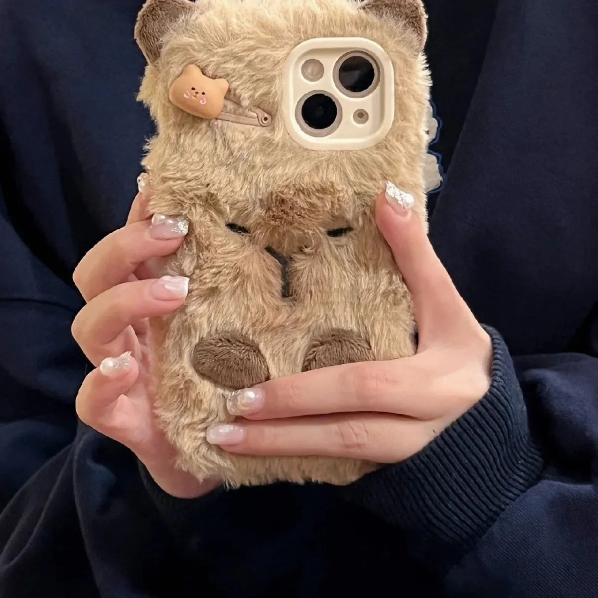 Brown flannel Capabala phone case with plush furry cartoon design for iPhone models