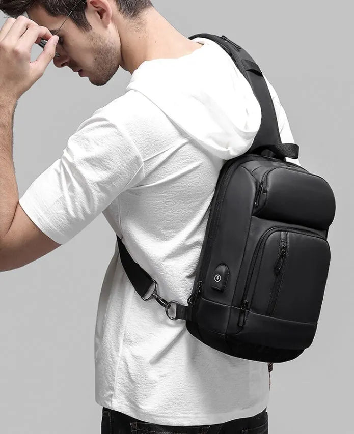 Black outdoor shoulder bag with air cushion strap and internal organisation compartments
