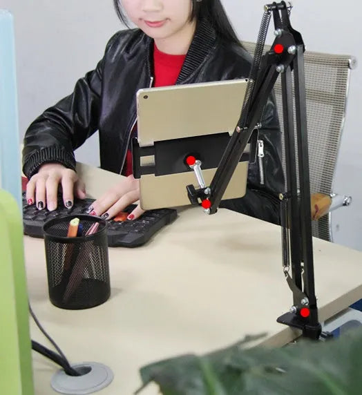 Black adjustable phone and tablet stand on a desk, measuring 10cm in height.