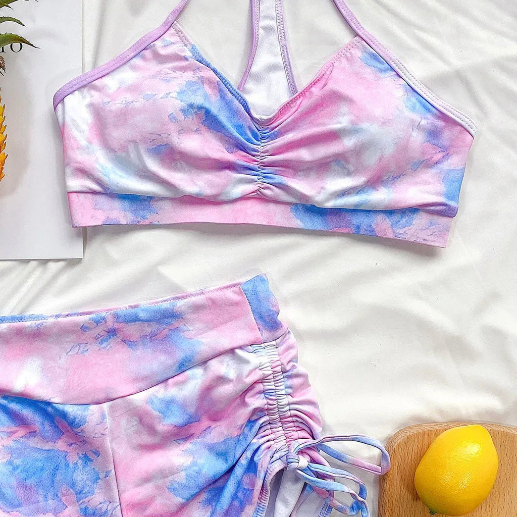 Tie-dye bikini shorts suit with push-up Brazilian top, nylon outer, polyester lining, light green or purple, sizes S to L.