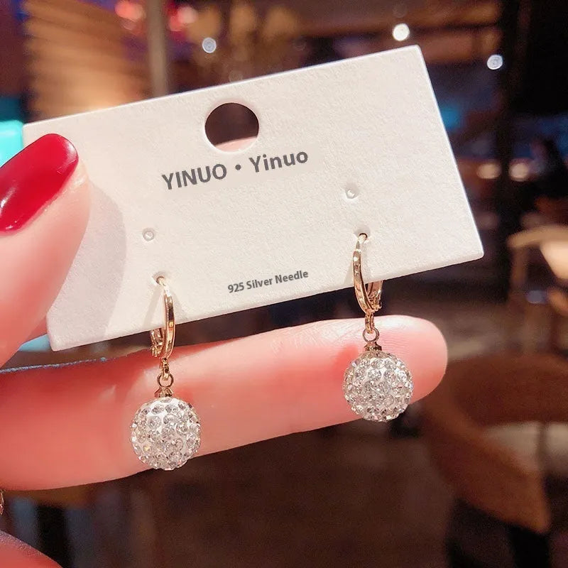 A pair of geometric-shaped zircon and rose element earrings for women, made from electroplated copper.