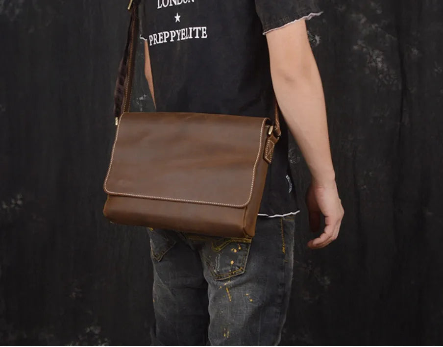 Vintage brown men's shoulder bag made of cowhide leather with adjustable strap and multiple internal pockets.