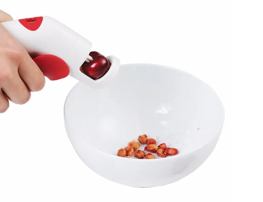 Stainless steel cherry kernel remover with 2.5cm plunger and 15cm handle on kitchen surface
