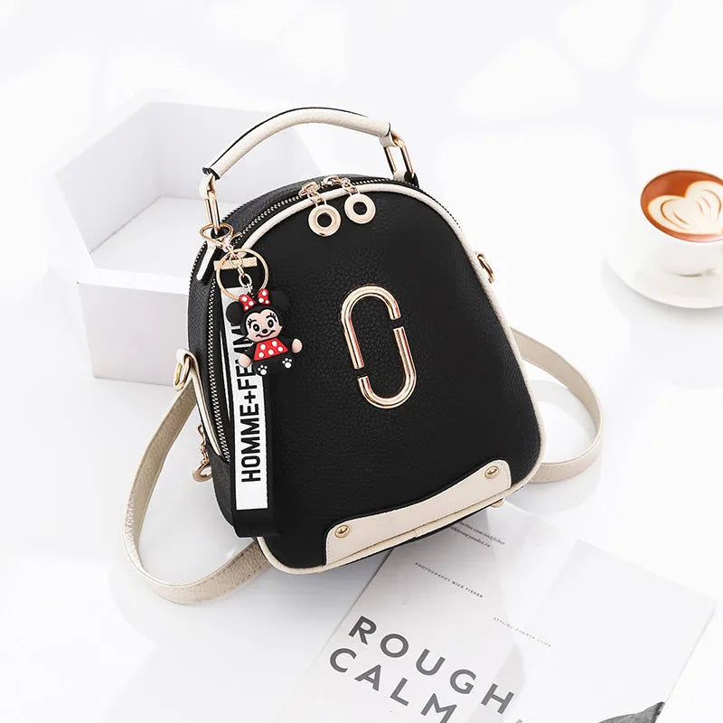 Women's PU leather oval fashion backpack with zip closure, multiple internal pockets and soft handle in white, red, black or pink