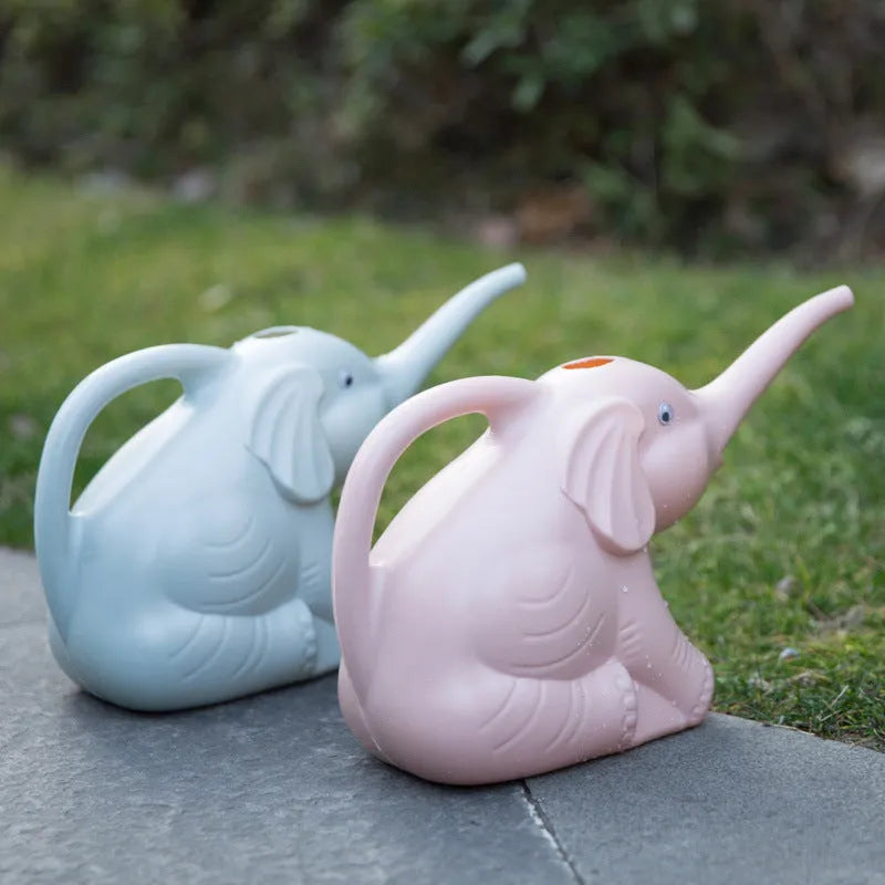 A pink plastic watering can shaped like a sitting baby elephant with a long spout.