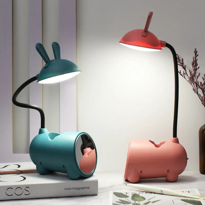 Green cartoon desktop lamp with pen container, USB cable, and modern simple design on wooden desk