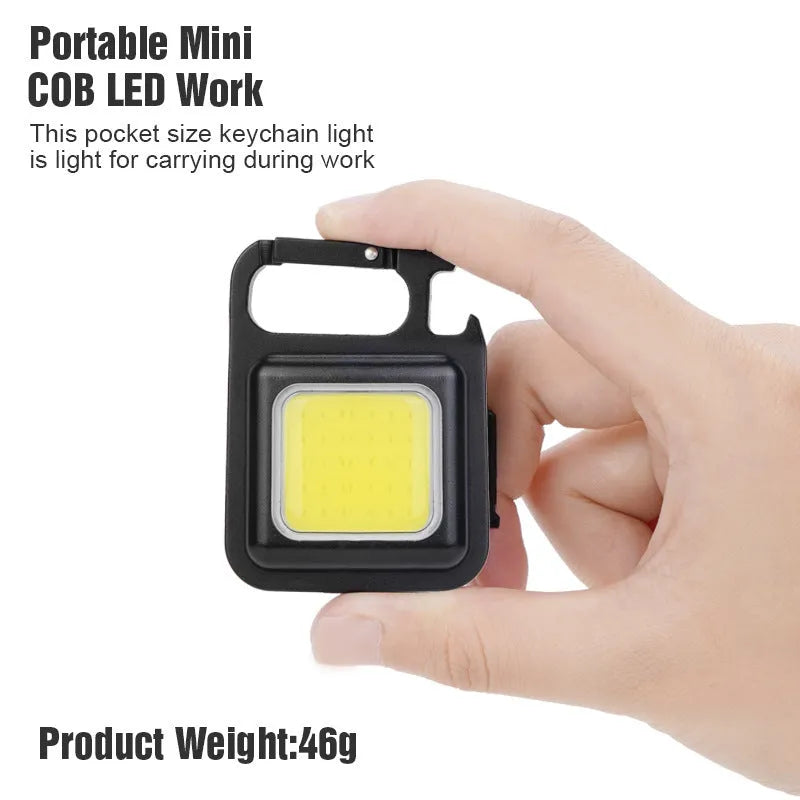 Black aluminium alloy keychain light with magnetic base and foldable handle, measuring 6 cm by 4.2 cm